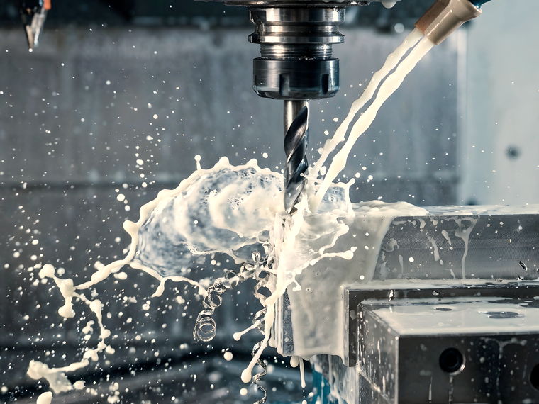 A cutting tool machining a metal component in a workshop